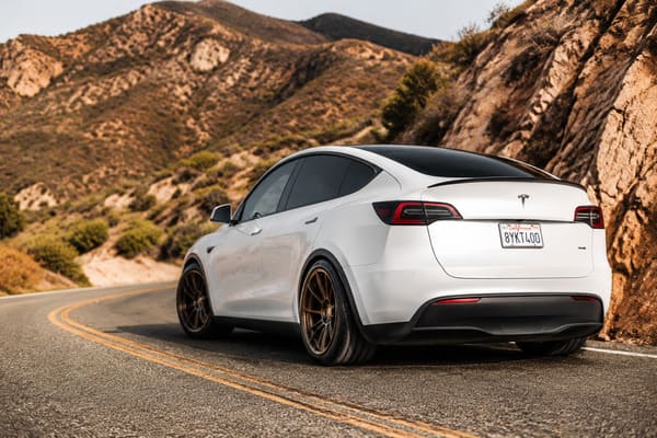 Bronze and gold forged wheels on white Tesla Model Y